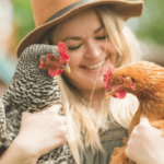 A woman holding two chickens