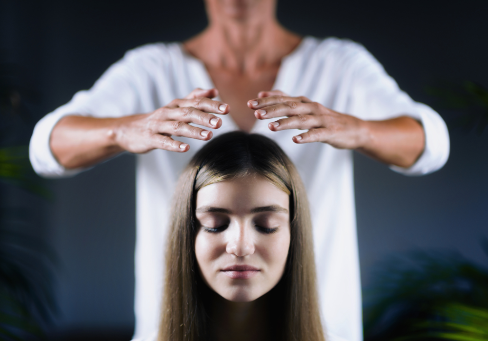 A woman receiving Reiki healing